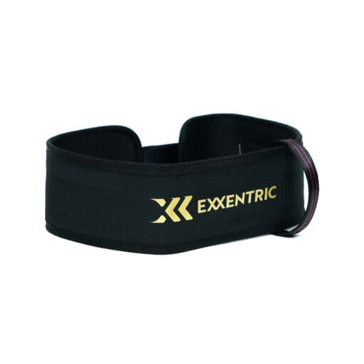 The Exxentric Squat Hip Belt is a black exercise belt with Exxentric in yellow on the side. It looks sturdy and adjustable, with a small loop for attachments, perfect for fitness or resistance training.