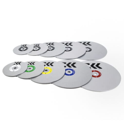 A set of ten Exxentric Flywheel weight plates for kBox 4, featuring silver metal plates with color-coded inner rings and arrow designs, arranged in descending size order.