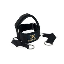 The Exxentric Head Harness is a black exercise harness featuring adjustable straps with metal rings, a padded handle, and the Exxentric logo on the front.