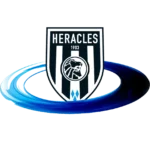 Heracles Almelo football club logo featuring a black and white shield with the word Heracles at the top, a lions head in the center, and 1903 above it. The shield is set against a swirling blue design.