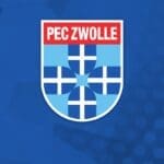 The image shows the PEC Zwolle logo, featuring a blue and white shield with a cross design in the center. The background is a blue gradient with hexagonal patterns and a faint soccer ball outline on the left.